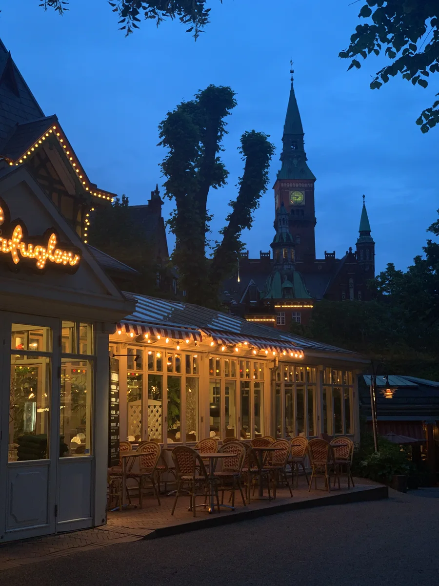 Warmly lit Tivoli buildings and towers at blue hour