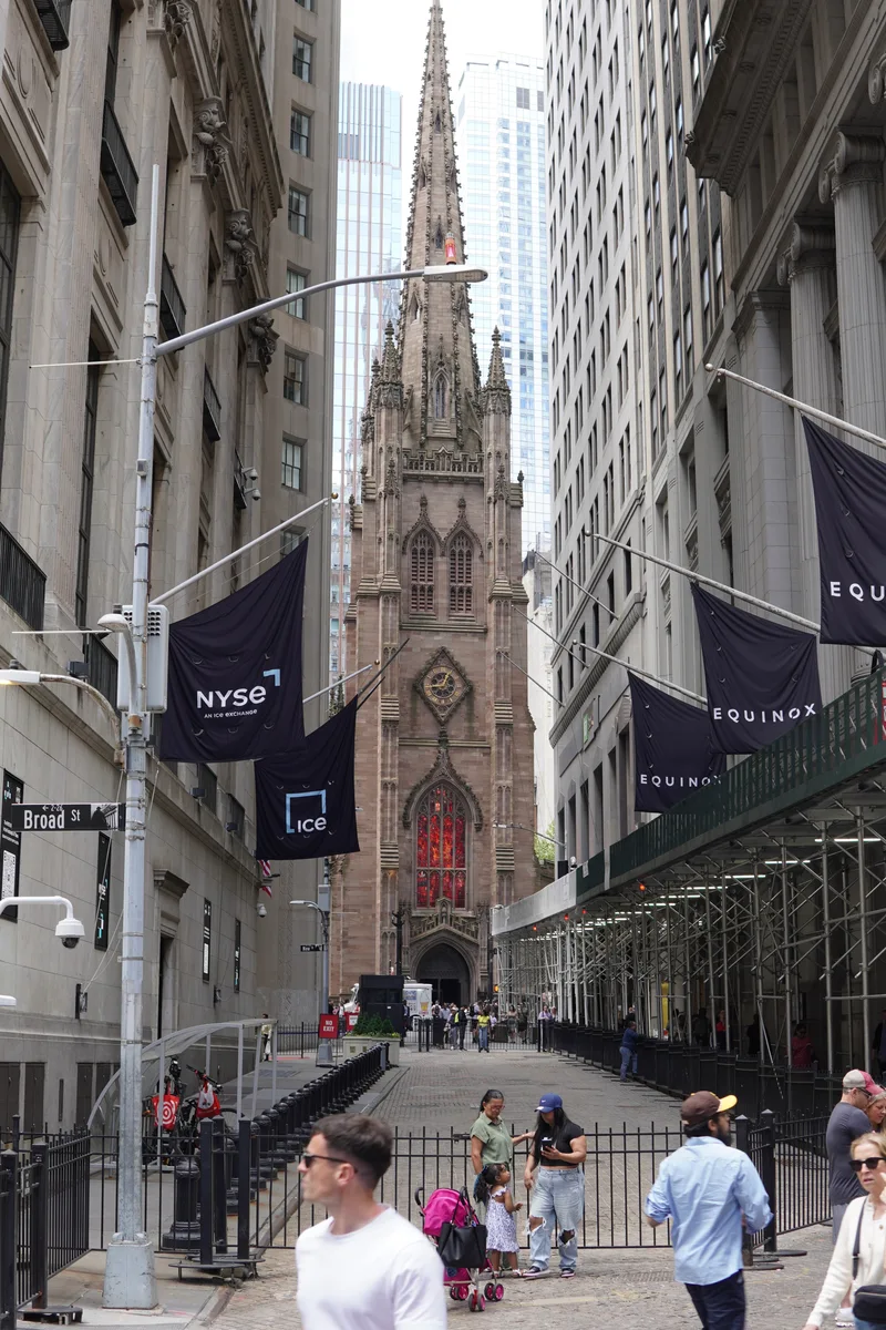 The façade of Trinity Church framed by tall buildings