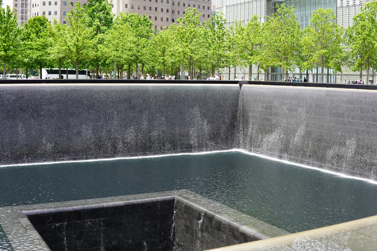 Trees beside a September 11 Memorial reflecting pool