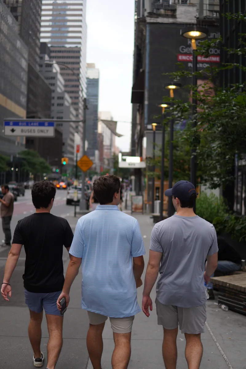 Pedestrians walking synchronized along a Manhattan sidewalk