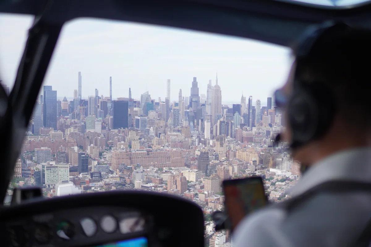 The Manhattan skyline seen past a pilot through an aircraft window